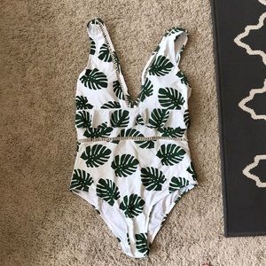 White one piece with leafy pattern